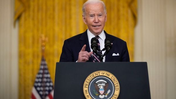 President Joe Biden speaks at podium.