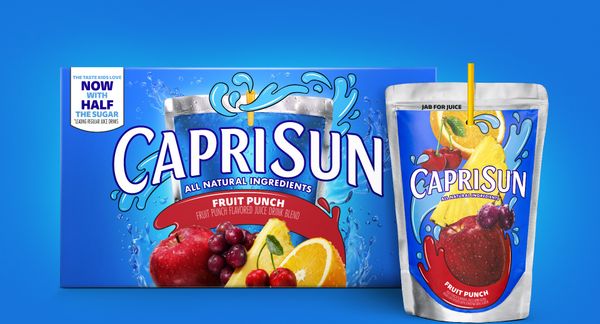 A box of Fruit Punch Capri Sun on a blue background with a juice pouch in the foreground.