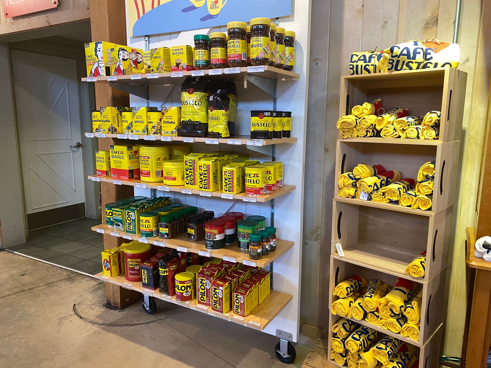 Bags and containers of Cafe Bustelo coffee on shelves in a store.